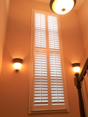 Polywood plantation shutters in well-lit stairwell.
